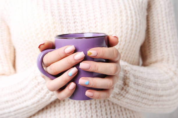istock Woman hands with manicure holding cup of coffee 2197646971