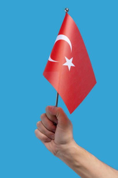 istock Hand holding Turkey Flag, isolated on blue background. 2197647130