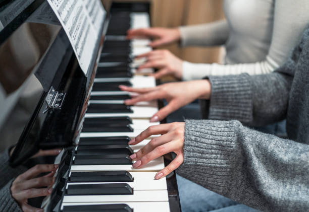 istock Close up of a women's hands playing the piano 2197650182