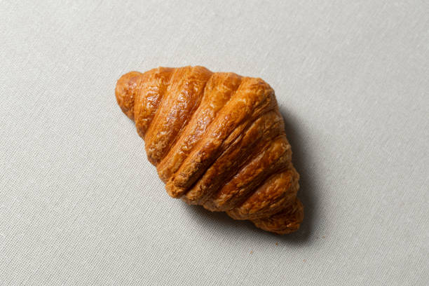 istock Delicious golden brown croissant resting on a tablecloth 2197650458