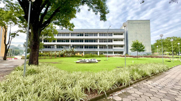 istock Sunny And Cloudy Day With A White And Gray Building And A Large Grass Ground With 2197652831