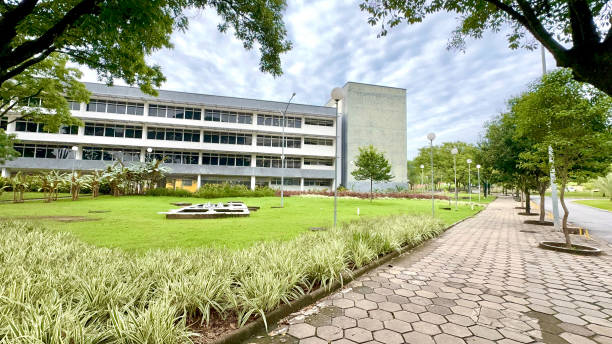 istock Sunny And Cloudy Day With A White And Gray Building And A Large Grass Ground With 2197652895