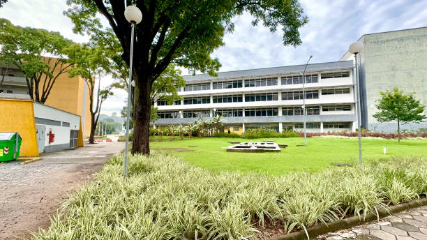 istock Sunny And Cloudy Day With A White And Gray Building And A Large Grass Ground With 2197652937