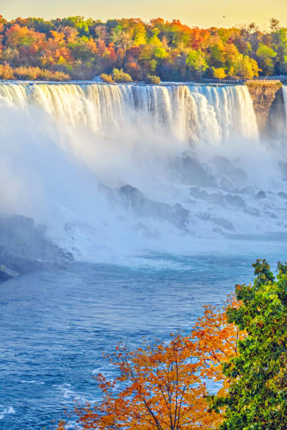 American Falls of Niagara Falls in autumn with colorful foliage colors. View from Canada