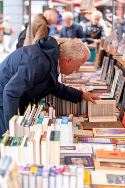Dordrecht, Netherlands - July 3, 2024: Visitors explore second-hand books at the annual book market in Dordrecht, 350 stalls throughout the city centre, where booksellers offer their best books.