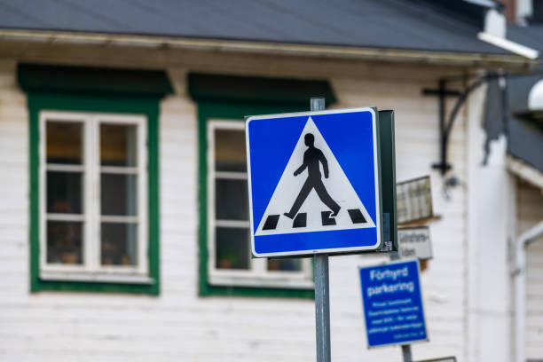 pedestrian crossing sign with urban background.