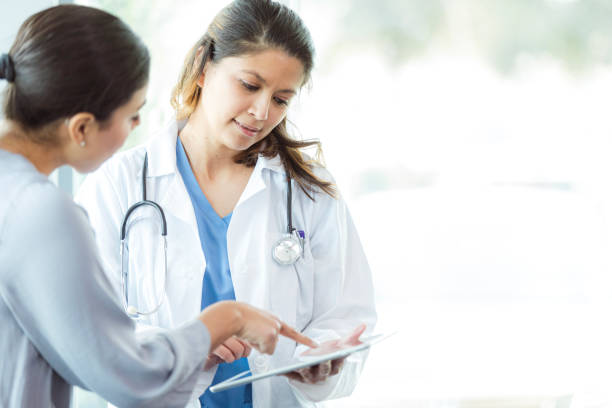 istock Doctor and Patient Discussing Treatment Plan on Tablet 2197657063