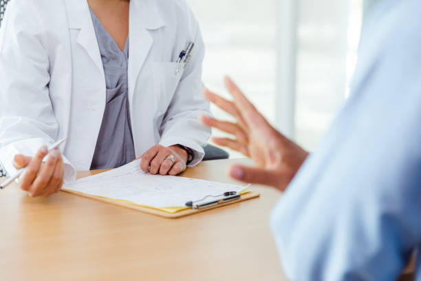 istock Doctor and Patient Discussing Medical Chart in Office 2197657114