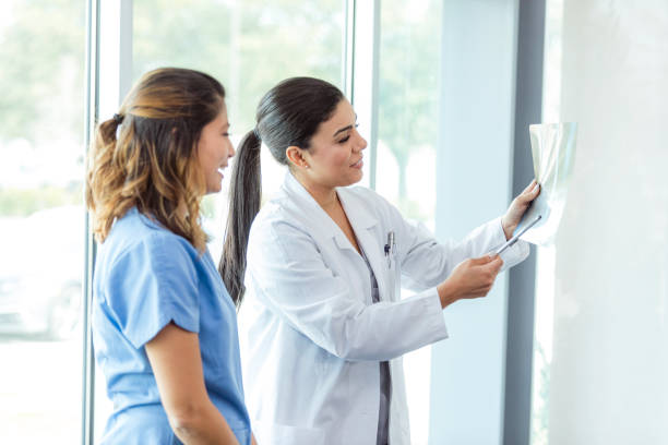 istock Doctor explaining X-ray to patient during medical consultation 2197657125