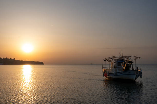 Fishing boat and sunset in Greece