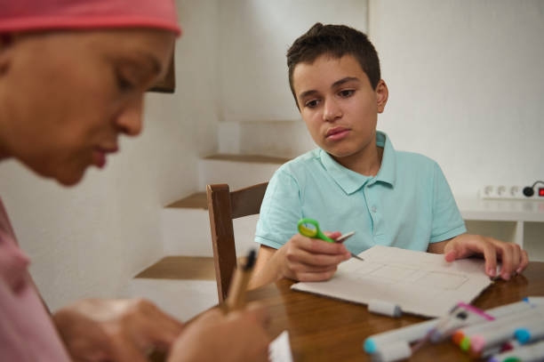 istock Boy studying at home with a supportive family member 2197659904