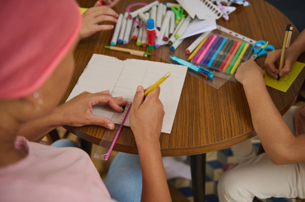istock Creative arts and crafts session with children drawing and coloring at a table 2197659920
