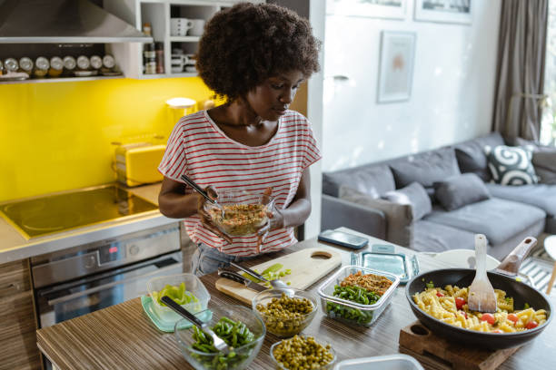 istock Woman cooking and organizing fresh meals in a well-lit modern kitchen space 2197667583