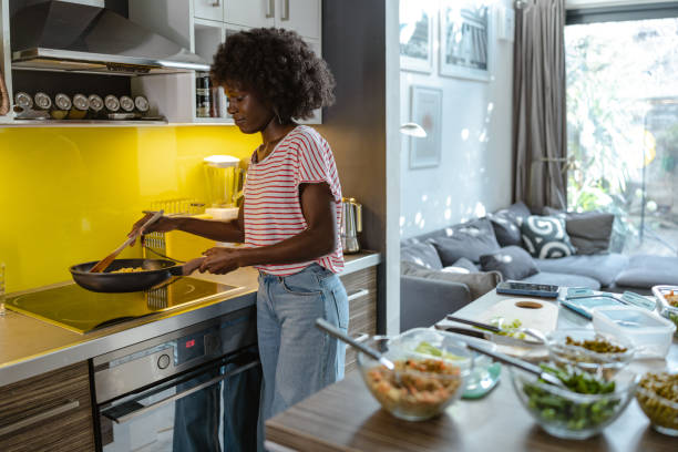istock Woman cooking pasta in a modern kitchen with fresh ingredients 2197667669
