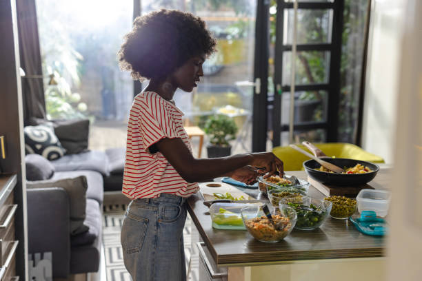 istock Woman preparing healthy meals in a kitchen with fresh ingredients 2197667708