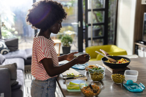 istock Woman preparing healthy meals in a kitchen with fresh ingredients 2197667824