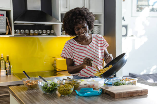 istock Person preparing and organizing food containers for meal prepping in a modern kitchen 2197667904