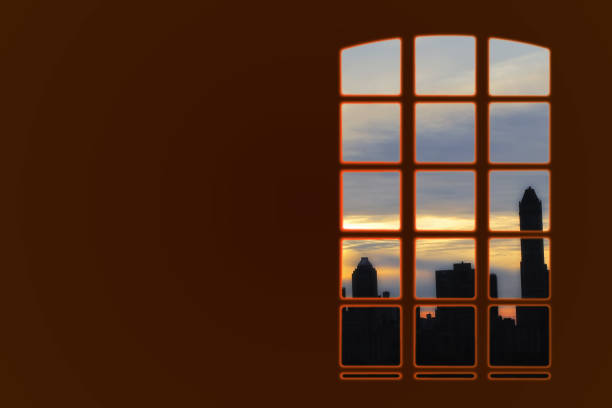 Sunset paints the sky with a warm gradient over an urban skyline, framed through a window segmented with a defined grid, creating depth with dramatic contrast.
