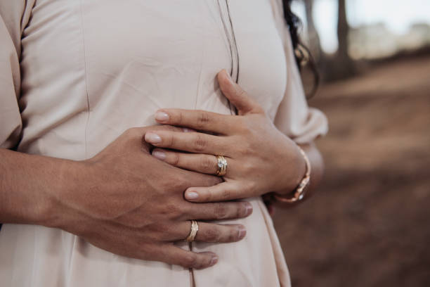 istock hands of a couple with engagement rings 2197670875