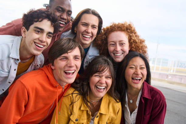 istock Group portrait several cheerful young people smiling outdoors. Multiracial joyful friends together. 2197671138