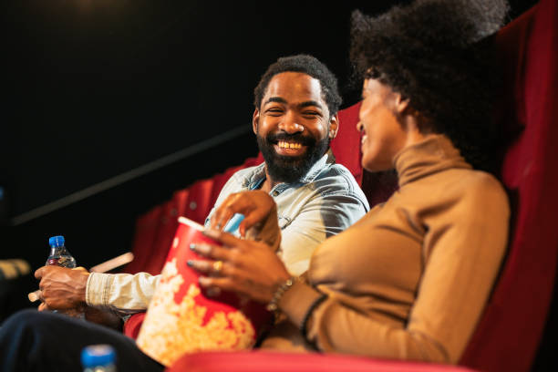 istock Joyful pair laughing while watching a movie in the cinema 2197673039