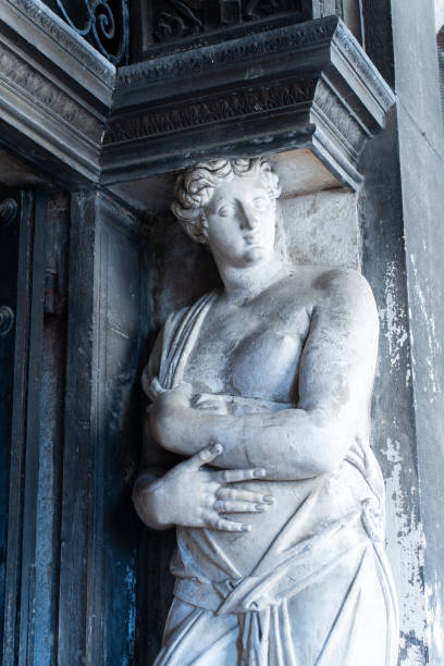 A striking caryatid statue supporting the upper part of a historic doorway in Piazza San Marco, Venice.