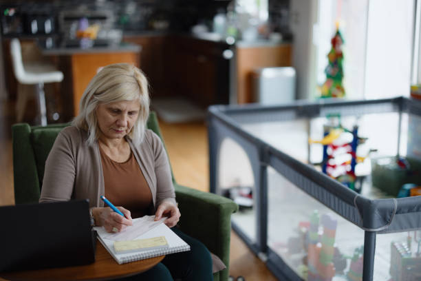 istock Woman Managing Finances at Home with Checkbook and Laptop 2197674071