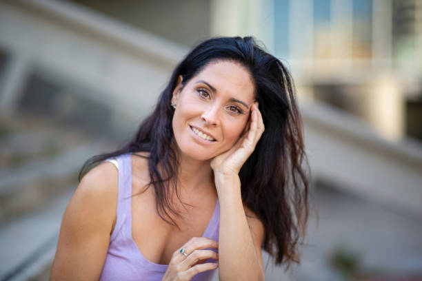 istock Beautiful woman smiling outdoors in city 2197674849