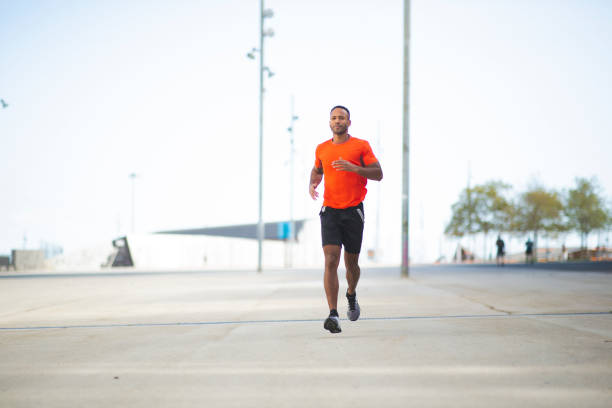 istock Healthy man jogging in city 2197674963