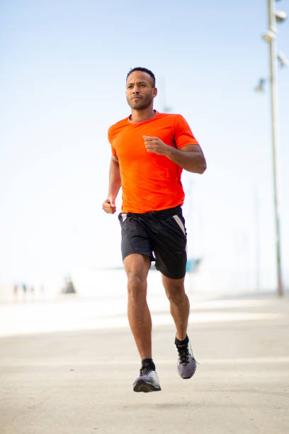 istock Young fit man jogging in city 2197674968
