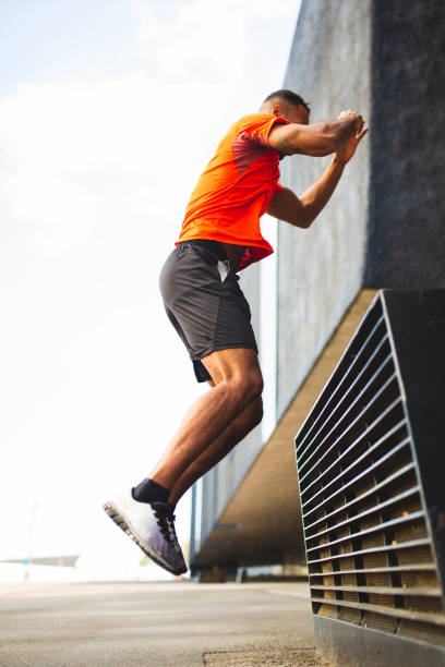 istock Man doing high jump exdercise outdoors in city 2197675045