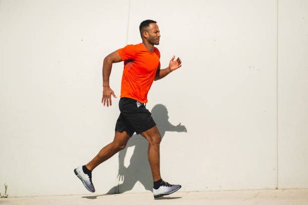 istock Man jogging outdoors on a bright sunny day 2197675047