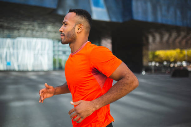 istock Confident sportsman jogging outdoors in city 2197675056
