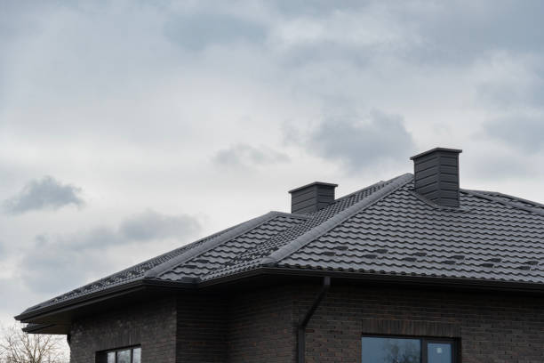 istock Two chimneys on a metal-covered roof on a clouds day 2197675434
