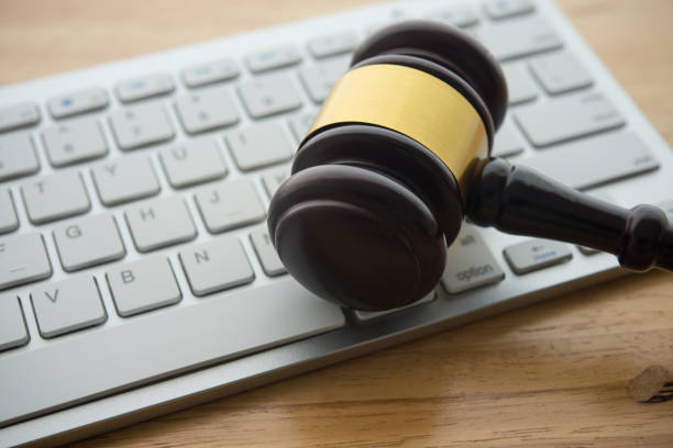 istock Judge hammer gavel on computer keyboard wooden table background. 2197675507