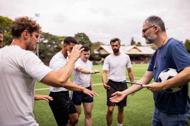 istock Soccer Coach Giving Tactical Instructions to Players 2197676356