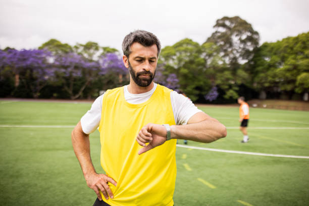 istock Soccer Player Glancing at Wristwatch During Training 2197676706