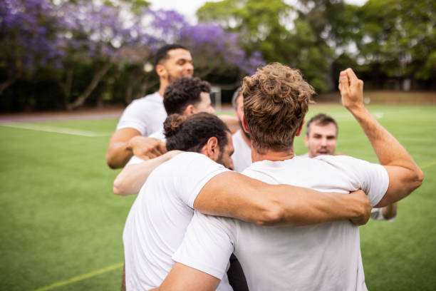 Group of soccer players celebrates a successful goal, sharing the joy of the moment with teammates on the field.