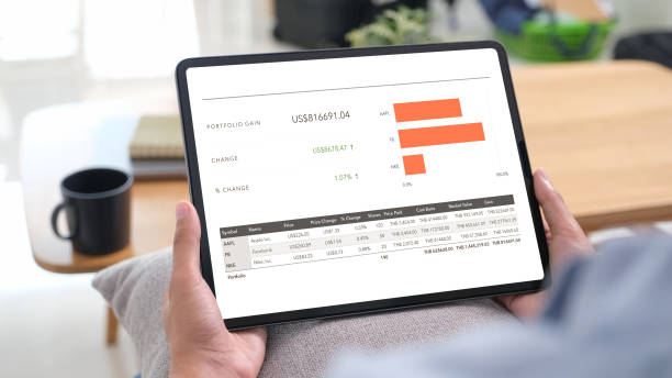 istock Hand holding digital tablet with stock market statistic data on screen, Telefinance, Business Technology and Lifestyle 2197677950