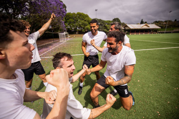 istock Soccer Team Celebrating Victory 2197678297