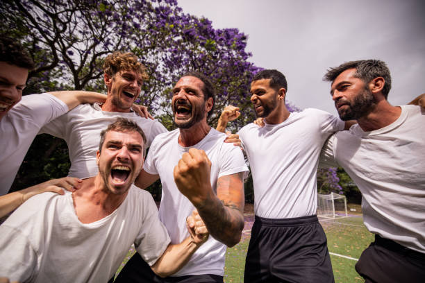 istock Excited Soccer Players Celebrating Victory 2197678310
