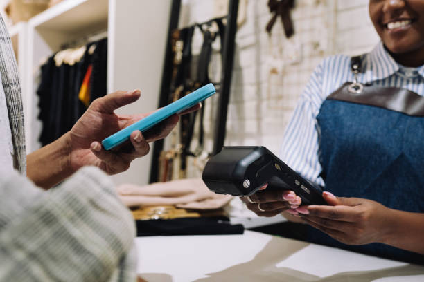 istock Close up of customer paying for merchandise with his mobile phone 2197678675