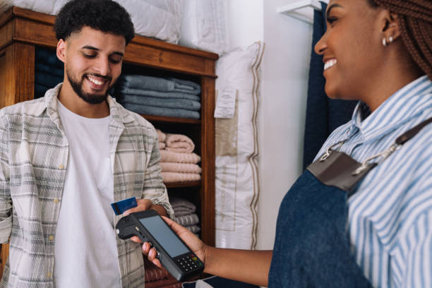 istock Saleswoman receiving a payment from a customer 2197678678