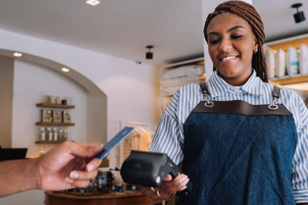 istock Saleswoman receiving a payment from a customer 2197678680
