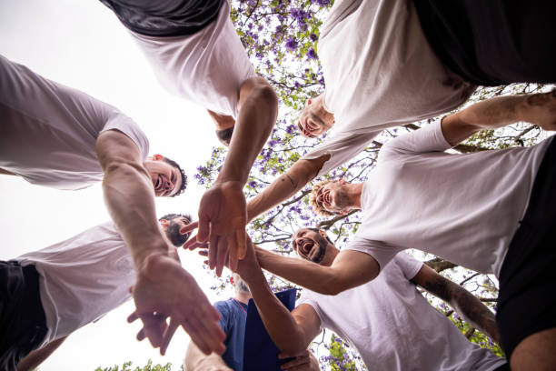 istock Coach and Players Holding Hands in Pre-Match Huddle 2197683219