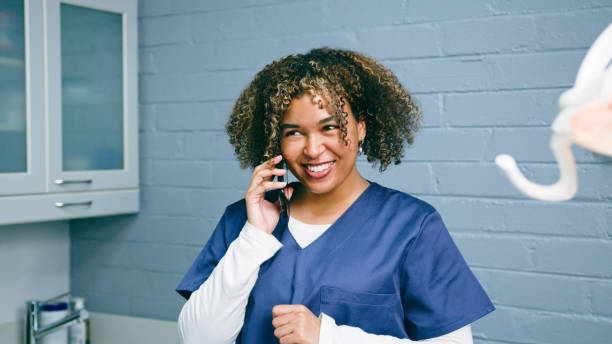 istock Smiling Medical Professional Holding a Phone in a Modern Clinical Office Setting 2197686064