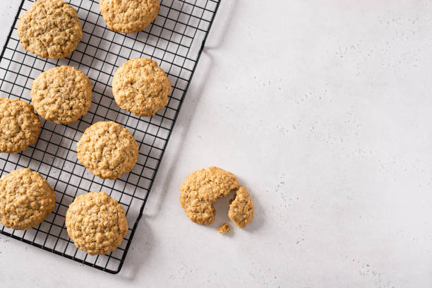 istock Healthy oatmeal cookies with nuts on white background. Bakery menu, recipe. Side view 2197687075
