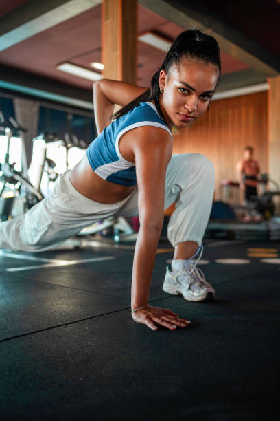 istock Hispanic Female Stretching In Gym With Determined Expression 2197688538