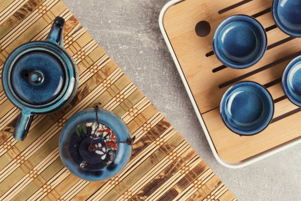 istock Tableware for tea ceremony top view. Blue tea set pottery on bamboo napkin. 2197690088