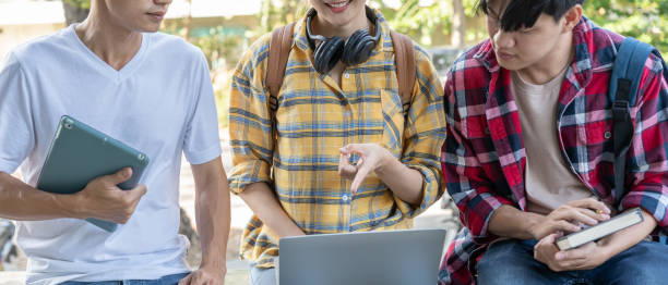 istock Group Asian student meeting team for work project. team happy study online. Read book in college campus. Group on international Asia University. Education, study, school, college, graduation 2197693655